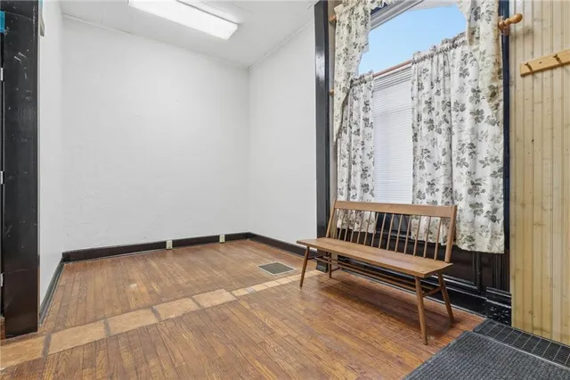 a view of a room with wooden floor and windows