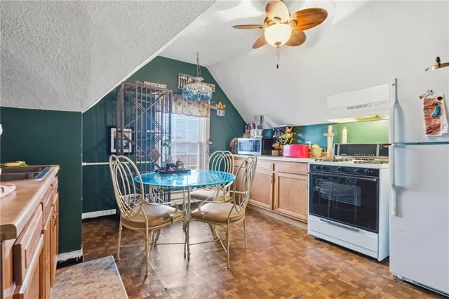 a kitchen with a table and chairs