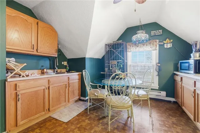 a dining room with furniture a rug a fireplace and a chandelier