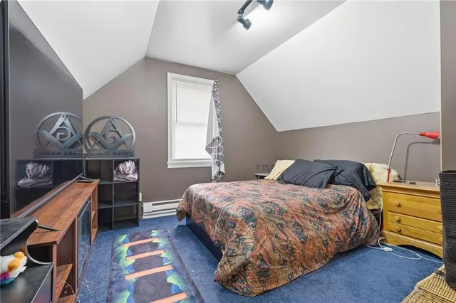 a bedroom with a bed a dresser and potted plants on the dresser