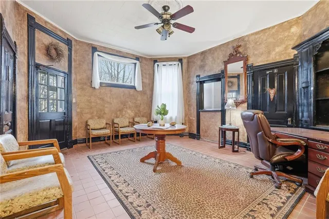 a living room with furniture a rug and a chandelier