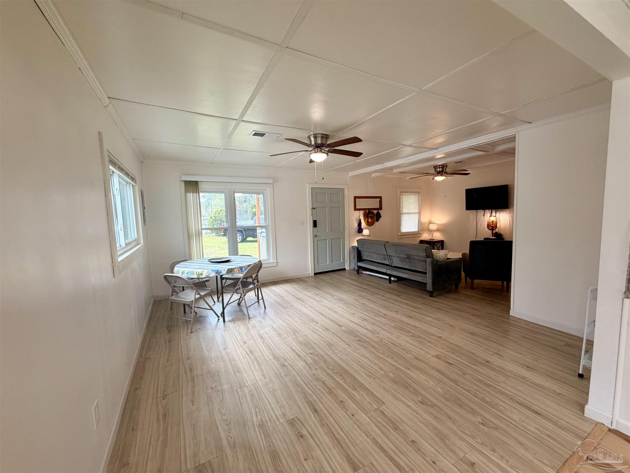 8816 Gibson Road Molino, FL 32577 - Photo 18 of 61 a living room with furniture and a wooden floor