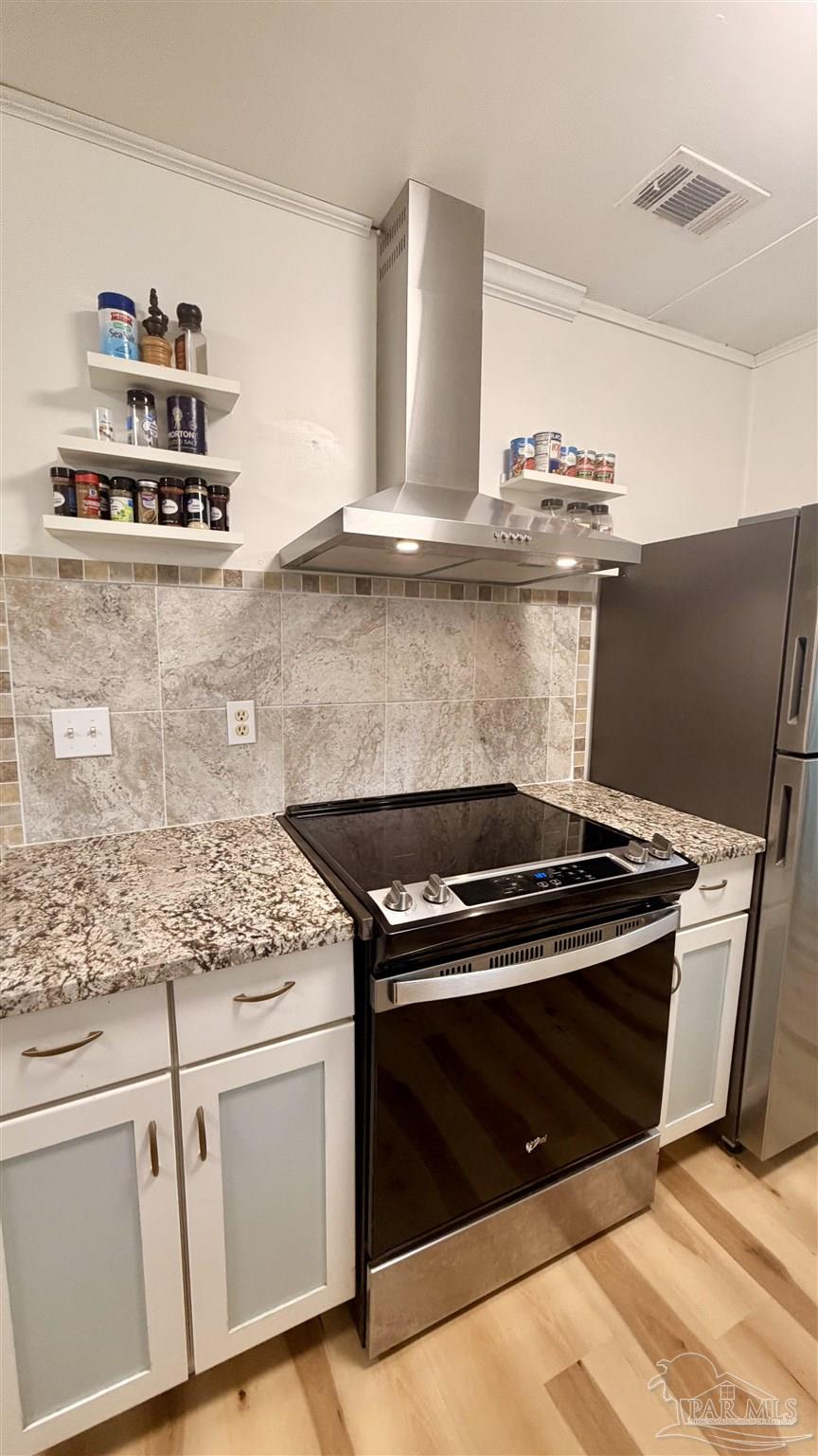 8816 Gibson Road Molino, FL 32577 - Photo 21 of 61 a stove top oven sitting inside of a kitchen