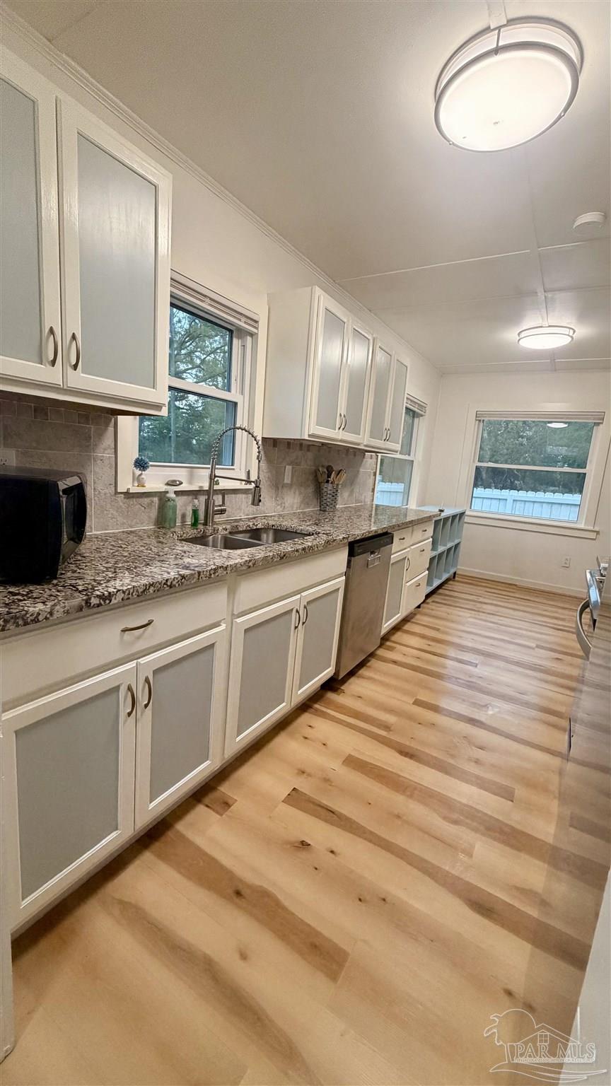 8816 Gibson Road Molino, FL 32577 - Photo 23 of 61 a kitchen with stainless steel appliances granite countertop a sink and cabinets