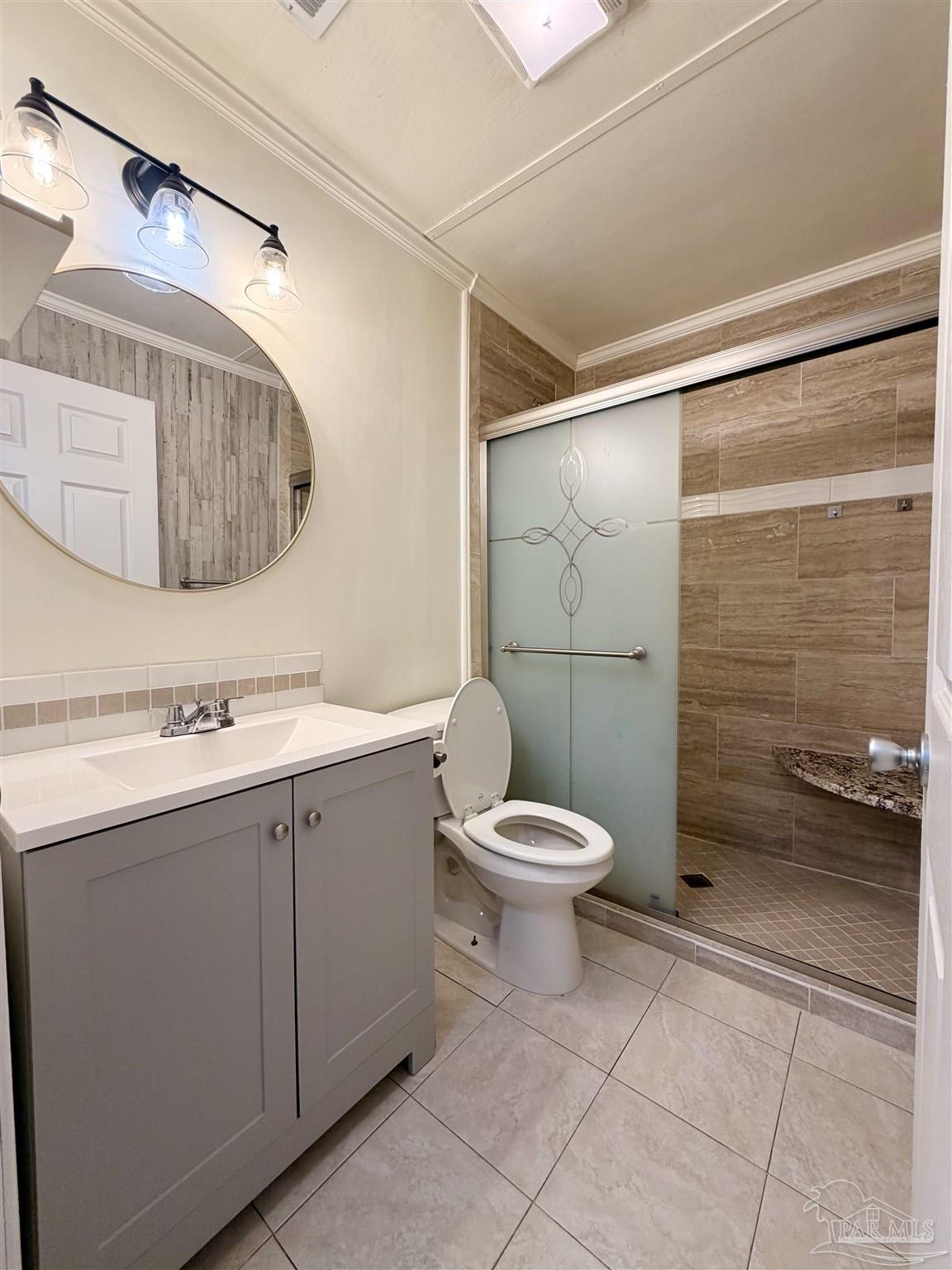 8816 Gibson Road Molino, FL 32577 - Photo 25 of 61 a bathroom with a toilet sink and shower