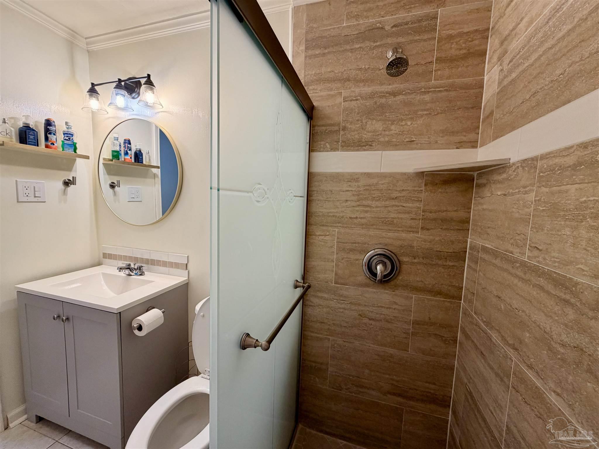 8816 Gibson Road Molino, FL 32577 - Photo 26 of 61 a bathroom with a sink a toilet and shower