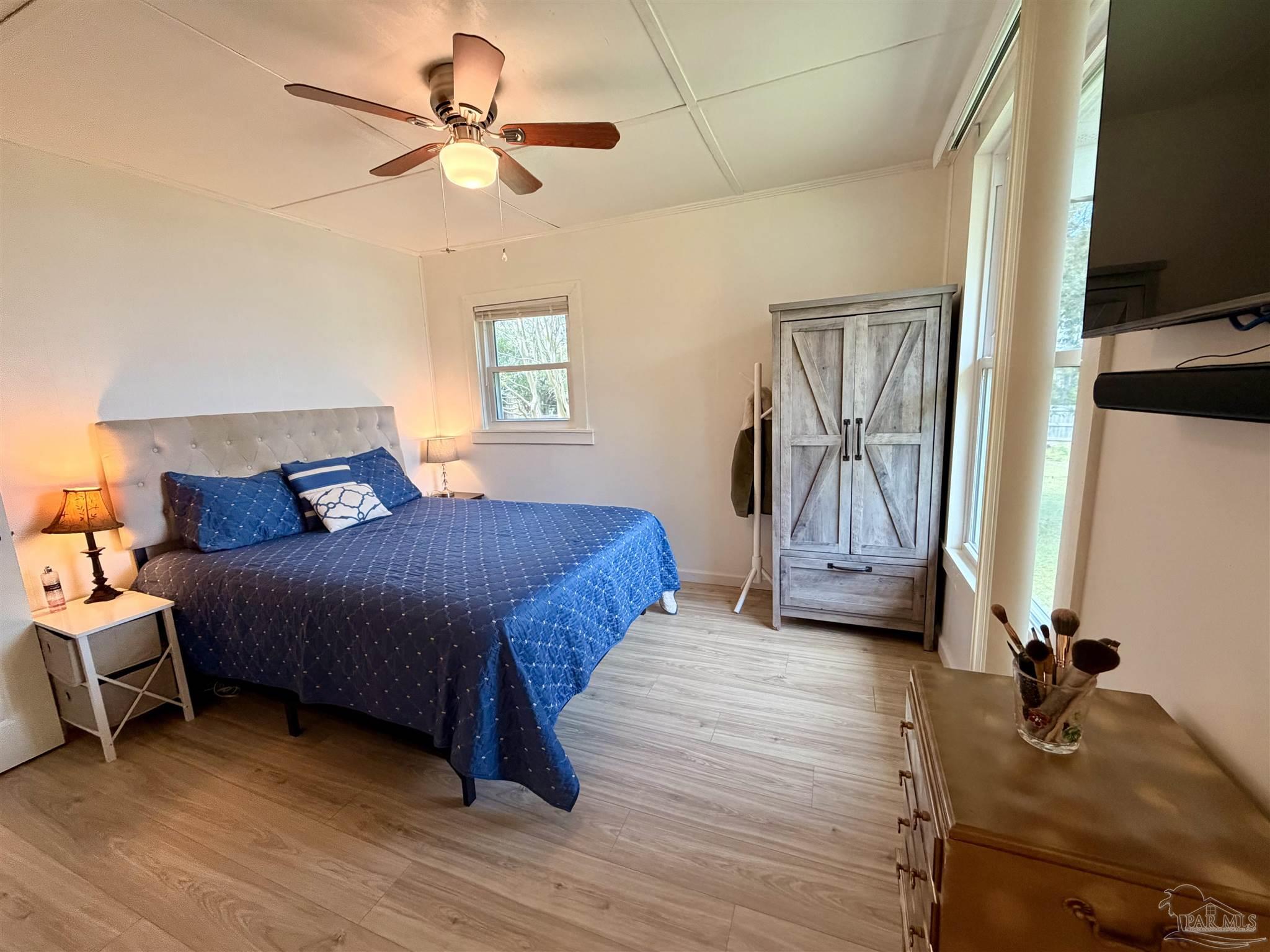 8816 Gibson Road Molino, FL 32577 - Photo 31 of 61 a bedroom with a bed and a chandelier