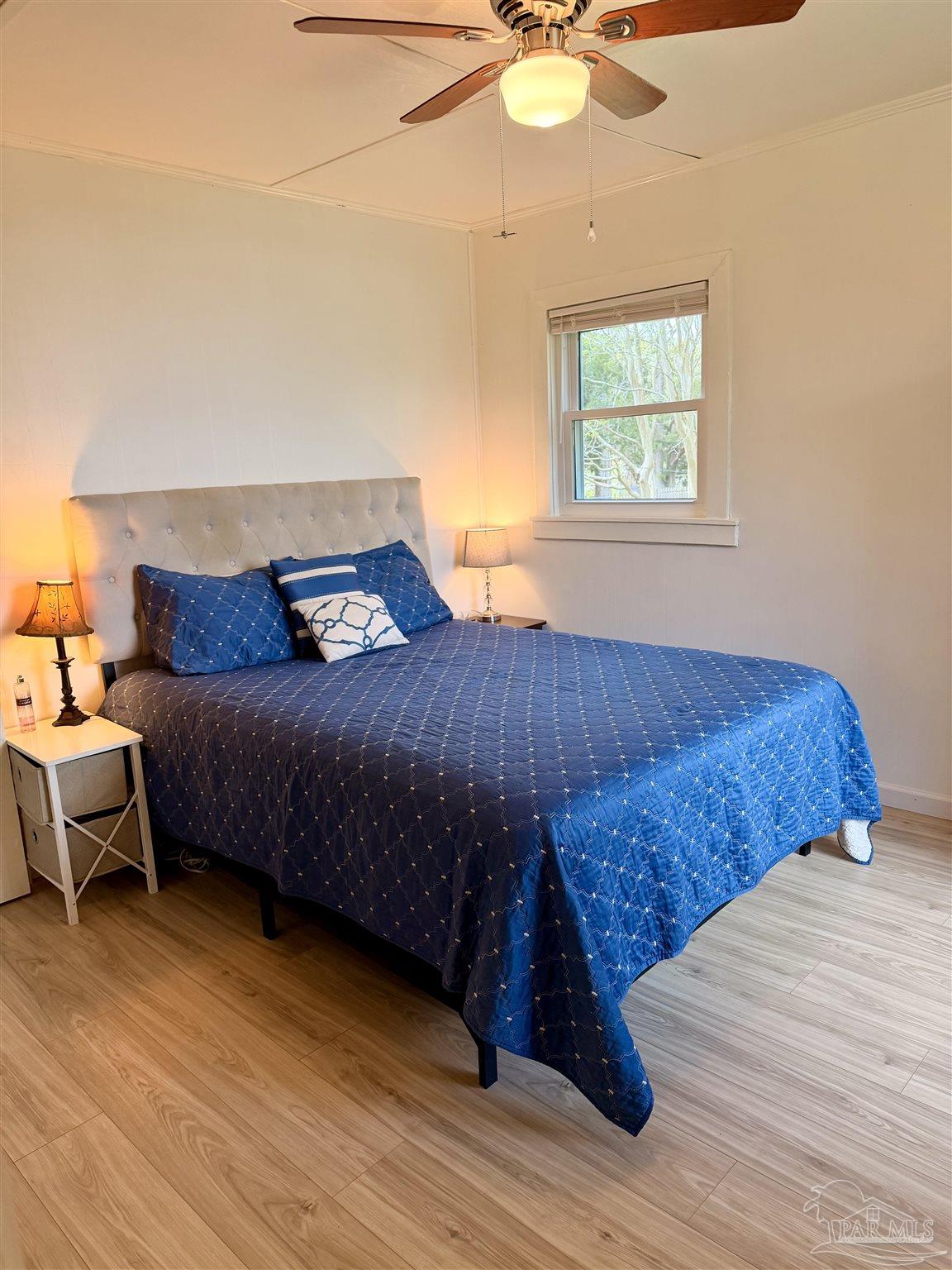 8816 Gibson Road Molino, FL 32577 - Photo 32 of 61 a bedroom with a bed and a chandelier