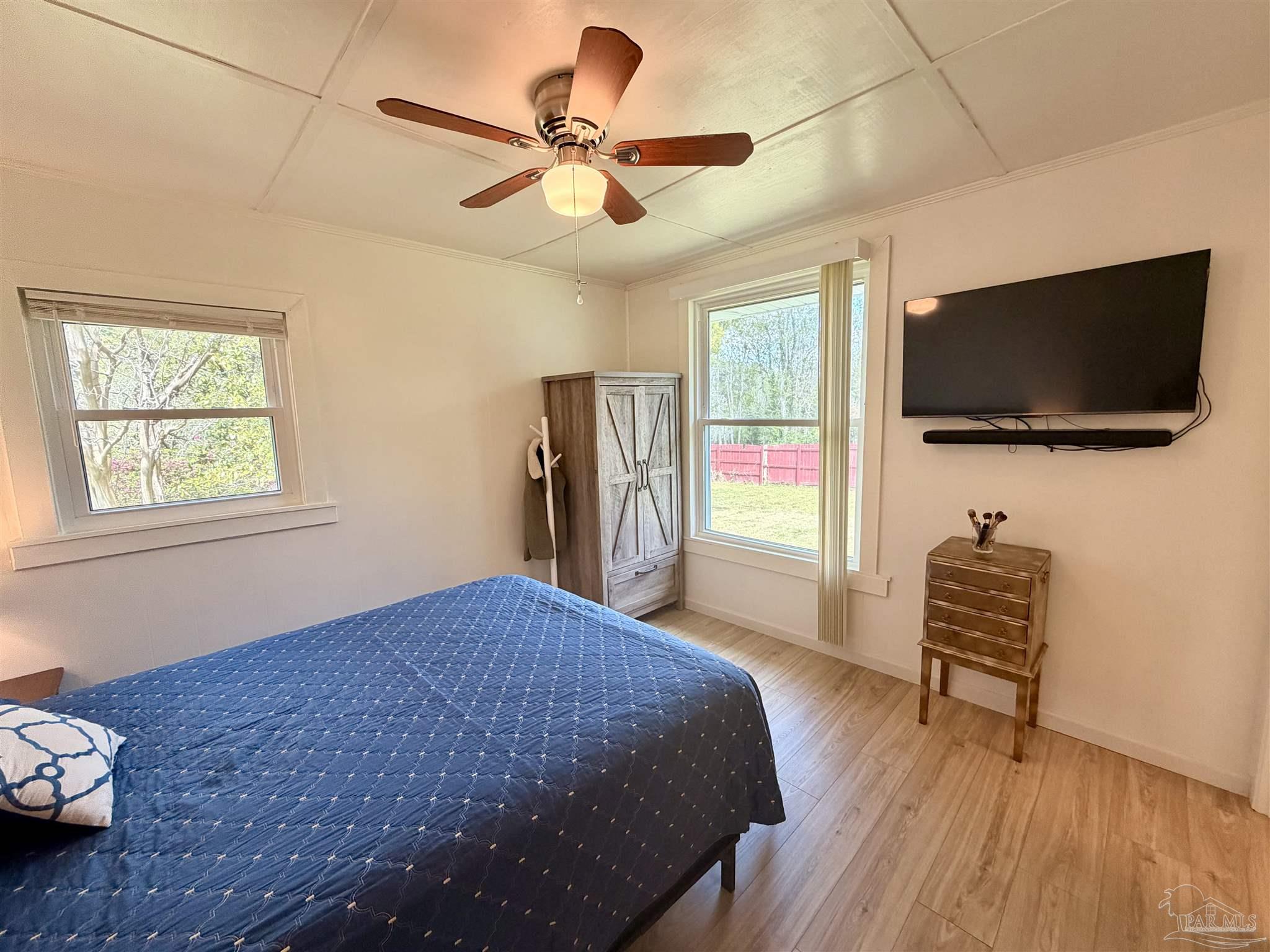 8816 Gibson Road Molino, FL 32577 - Photo 34 of 61 a bedroom with a bed and a television