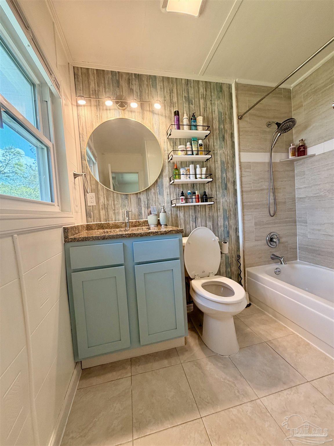 8816 Gibson Road Molino, FL 32577 - Photo 37 of 61 a bathroom with a toilet sink vanity granite and shower
