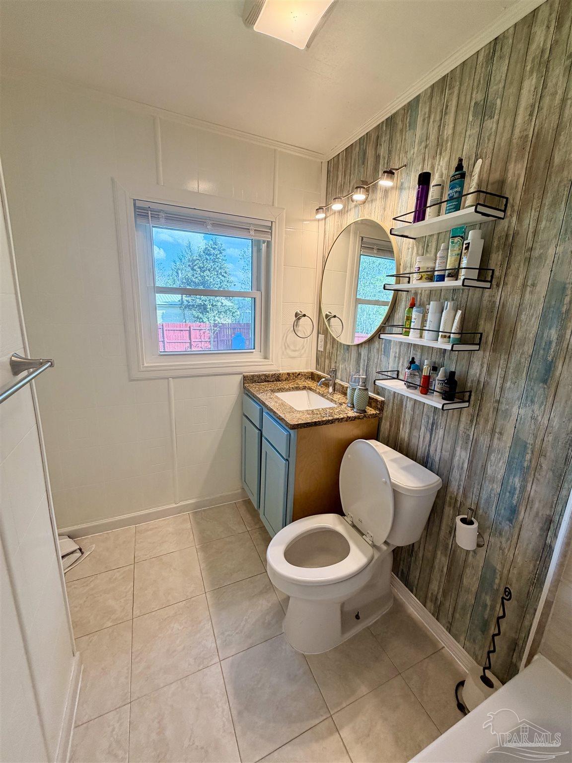 8816 Gibson Road Molino, FL 32577 - Photo 40 of 61 a bathroom with a toilet sink and mirror