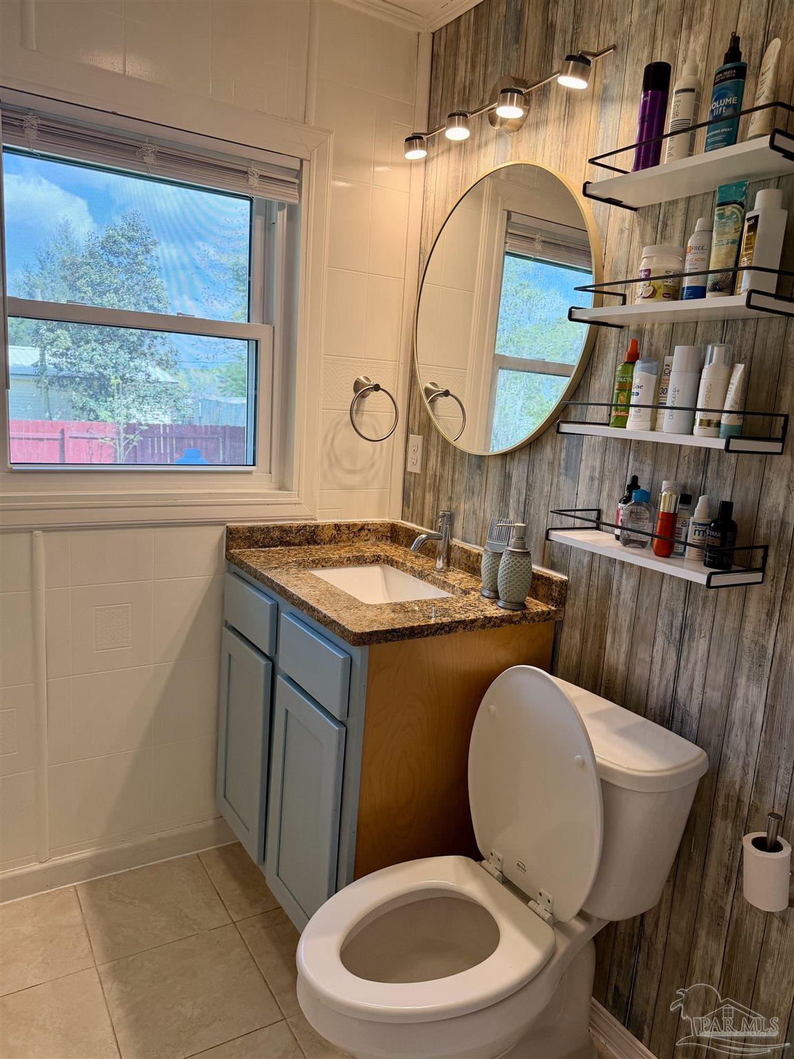 8816 Gibson Road Molino, FL 32577 - Photo 42 of 61 a bathroom with a toilet a sink and a mirror