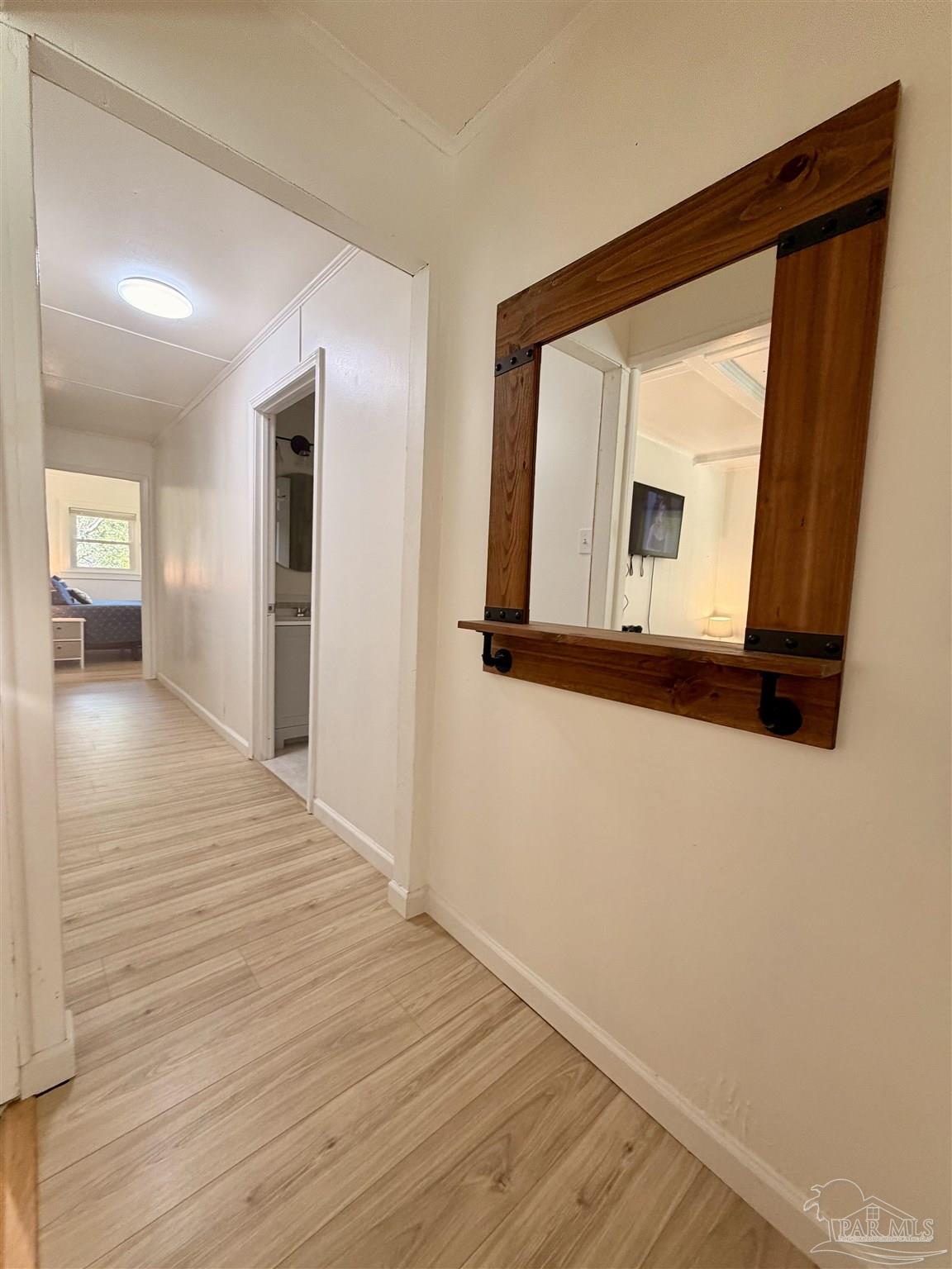 8816 Gibson Road Molino, FL 32577 - Photo 44 of 61 a view of a hallway with wooden floor and a bathroom