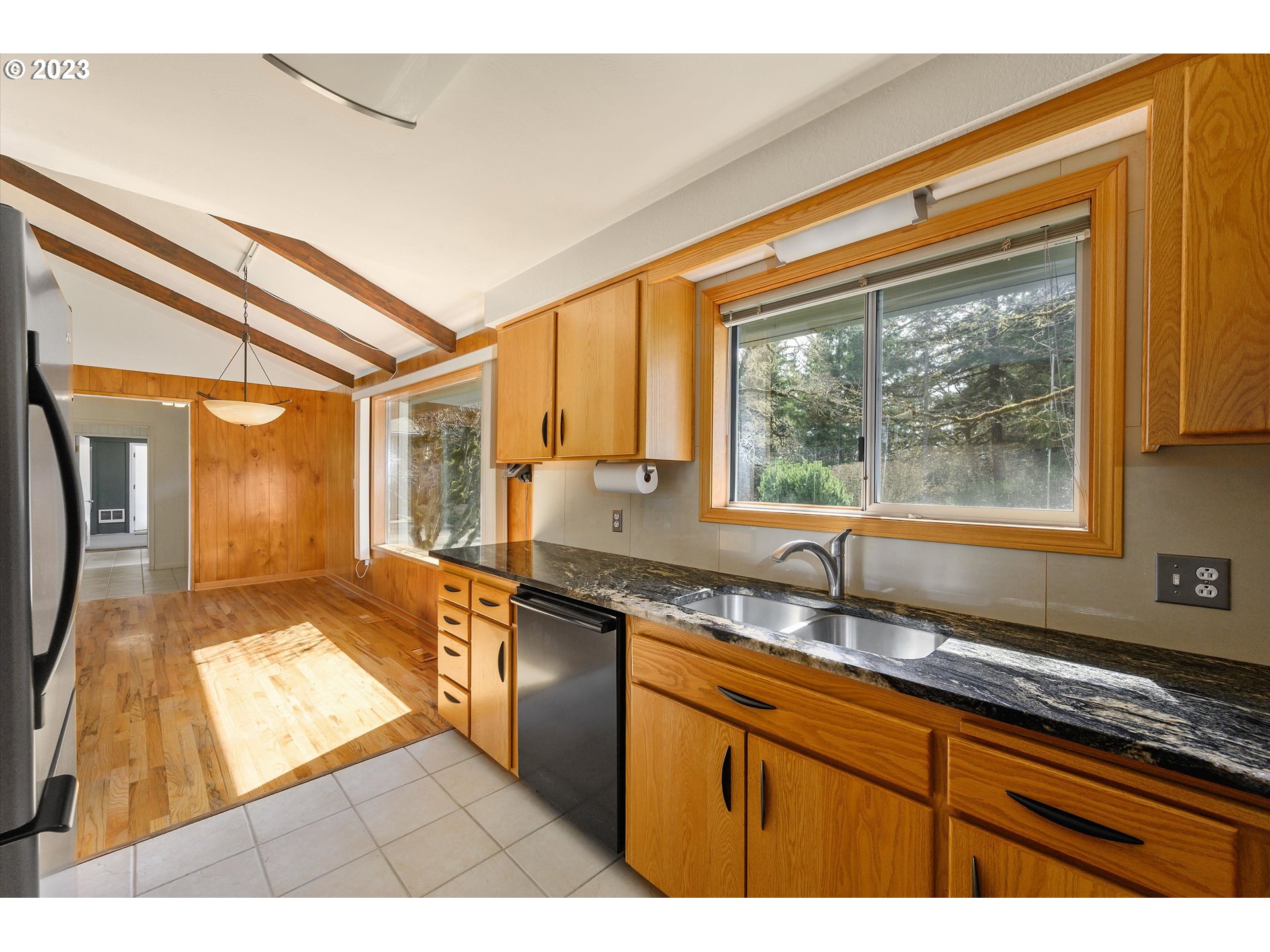 15775 Oakdale Road Dallas, OR 97338 - Photo 14 of 32 a kitchen with granite countertop a sink and a window