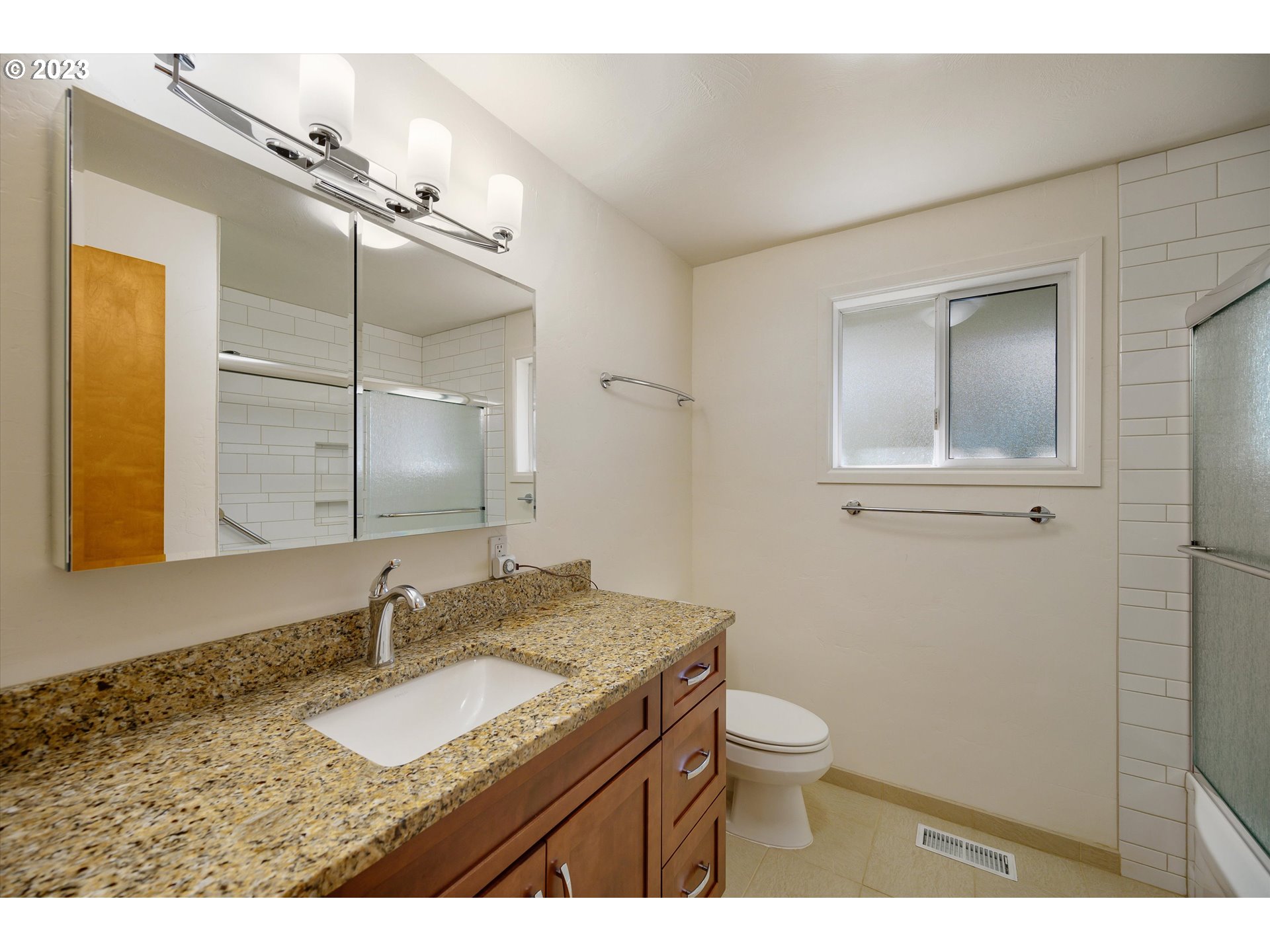15775 Oakdale Road Dallas, OR 97338 - Photo 23 of 32 a bathroom with a granite countertop sink a toilet and a mirror