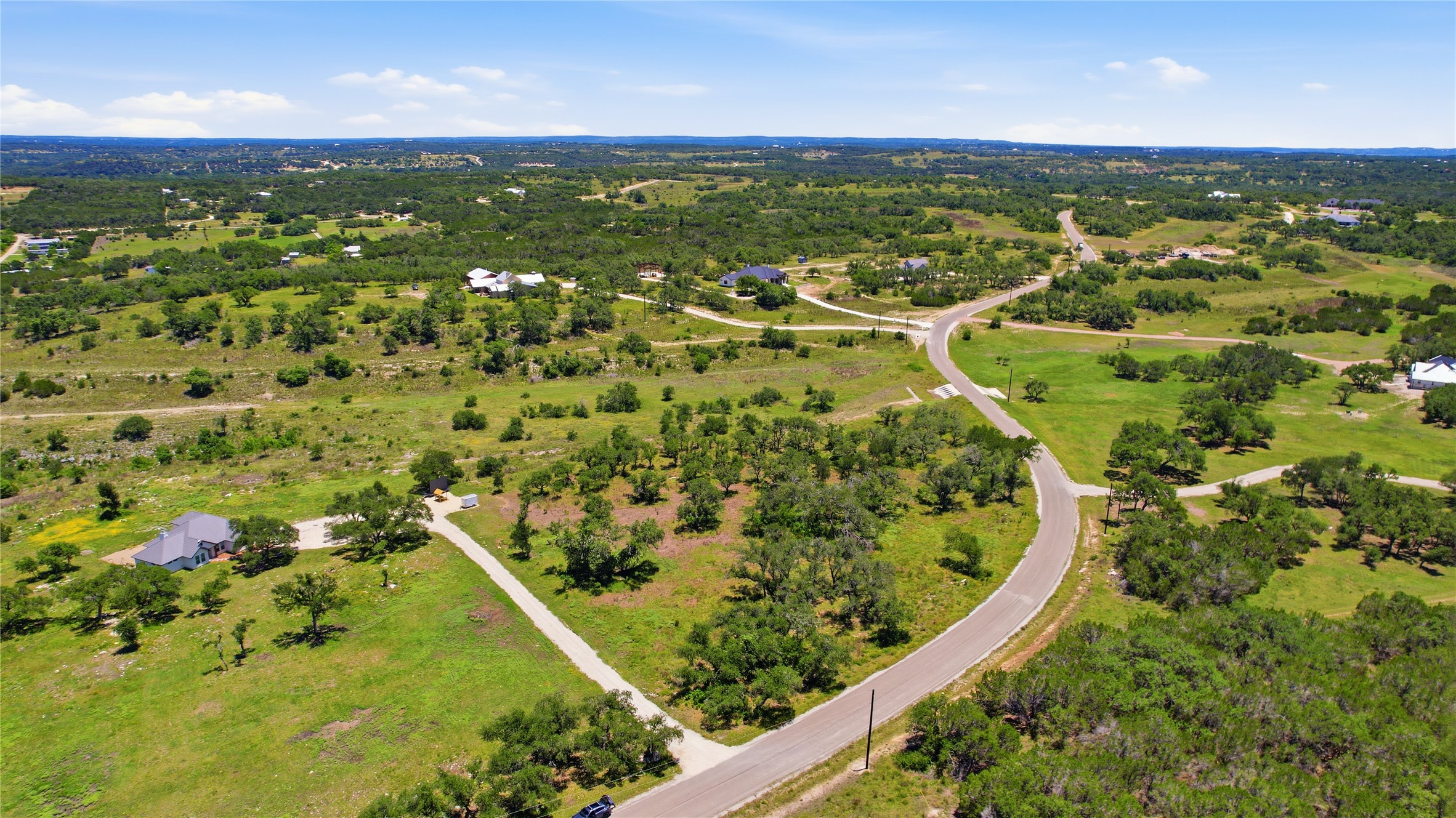 623 Whiskey Trail Blanco, TX 78606 - Photo 14 of 23 A winding road navigates a community with beautifully-built homes throughout