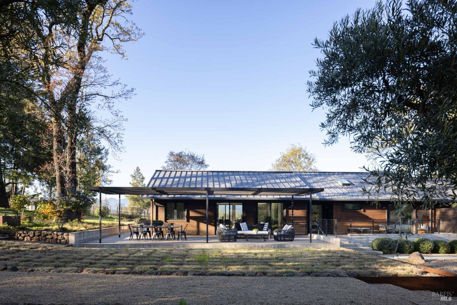 150 Petrified Forest Road Calistoga, CA 94515 - Photo 1 of 1 a view of a water fountain and a tree in front of the house