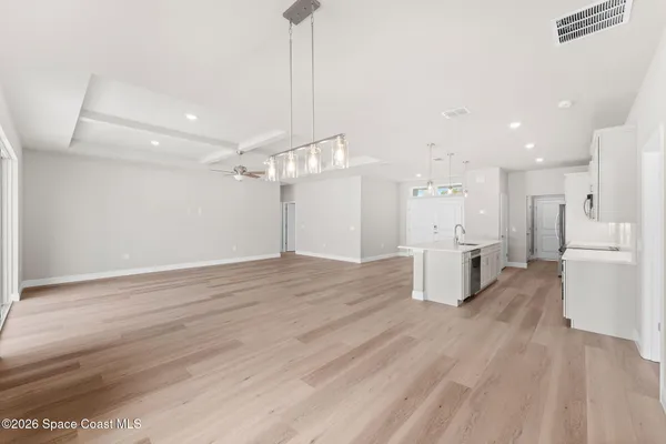 a view of a kitchen with a sink and a refrigerator