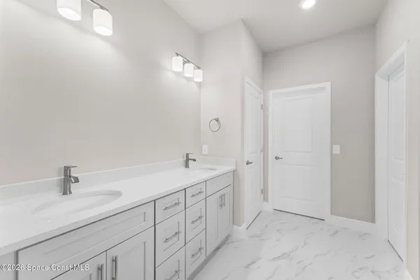 a bathroom with a double vanity sink and mirror