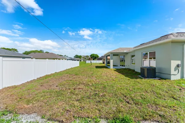 a view of house with yard and ocean view