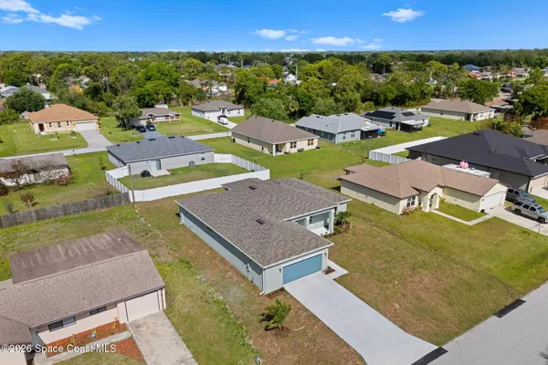 an aerial view of residential houses with outdoor space