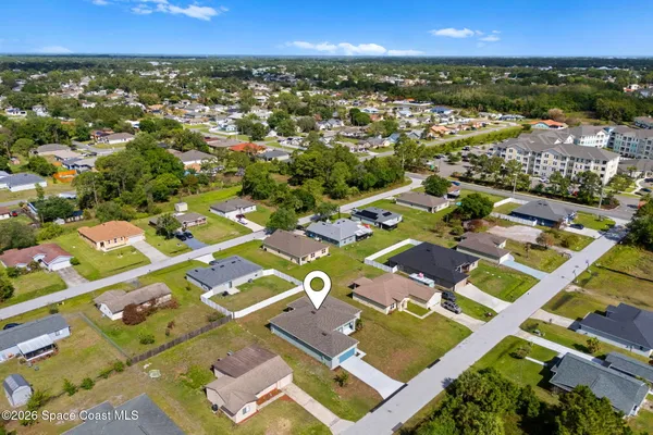 an aerial view of residential houses with outdoor space