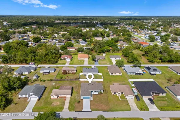 an aerial view of residential houses with outdoor space
