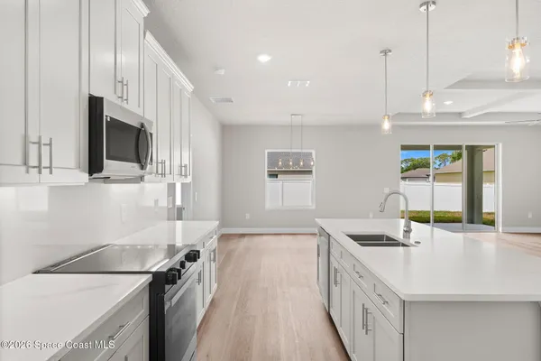 a kitchen with a sink a stove and a refrigerator