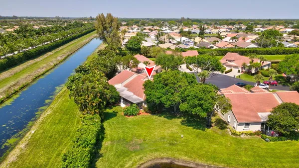 an aerial view of residential houses with outdoor space and trees all around