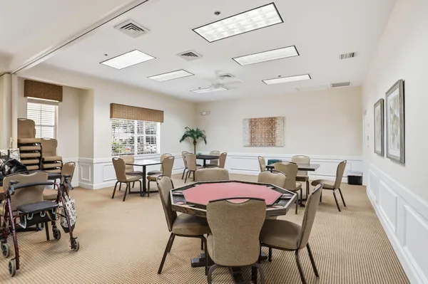 a dining room with furniture a chandelier and wooden floor