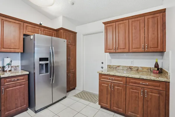 a kitchen with stainless steel appliances granite countertop a refrigerator and a sink