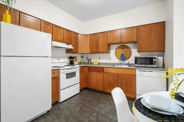 a kitchen with appliances a sink and a stove