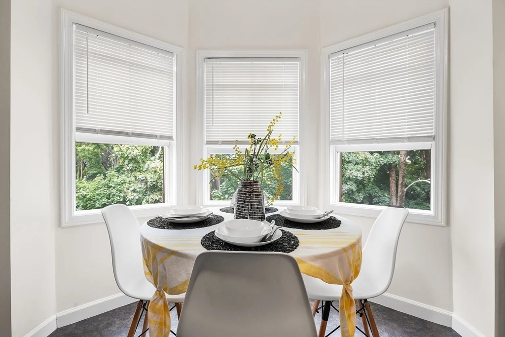 49 Cedar Street, Unit 2 REAR Boston, MA 02119 - Photo 6 of 12 a dining room with furniture window and wooden floor