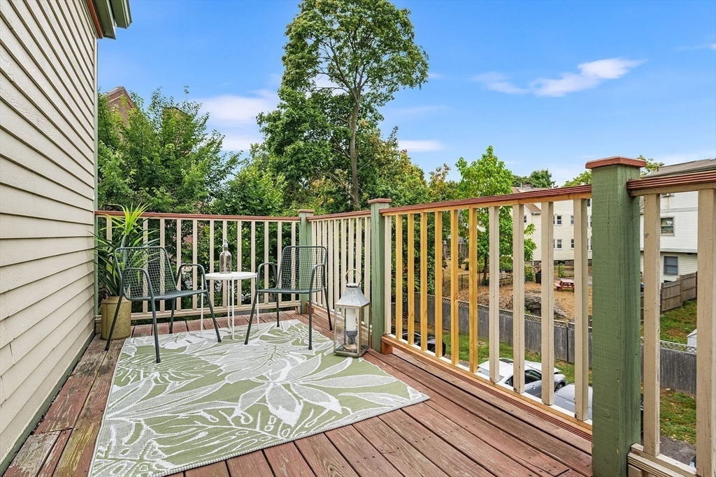 49 Cedar Street, Unit 2 REAR Boston, MA 02119 - Photo 8 of 12 a view of balcony with wooden floor