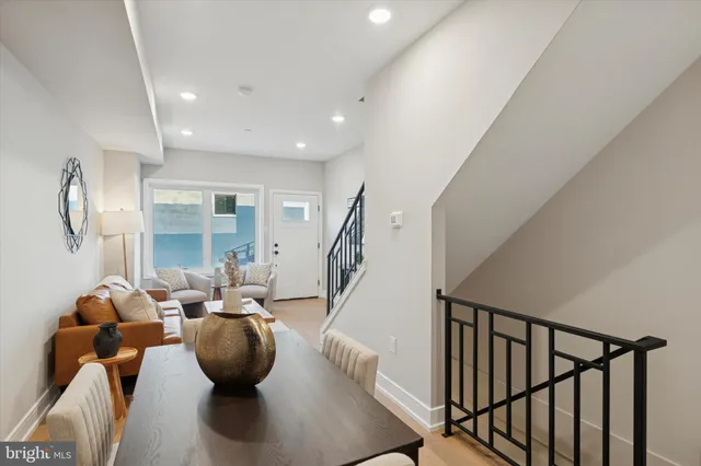 a living room with furniture wooden floor and a chandelier