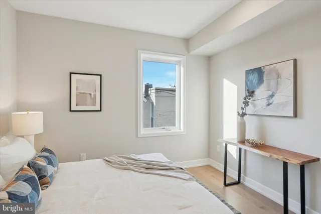 a bedroom with a bed and wooden floor