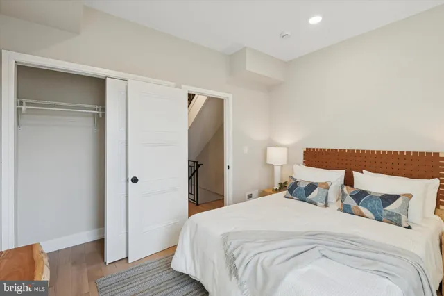 a bedroom with a bed and wooden floor