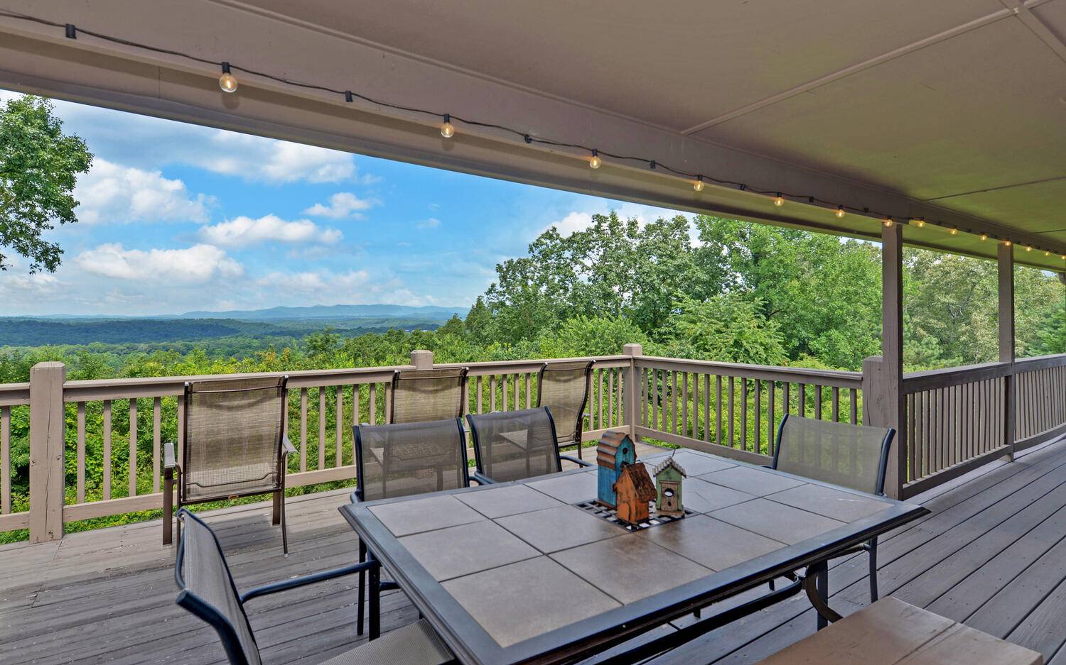 624 Talona Mountain Road Ellijay, GA 30536 - Photo 1 of 49 a view of a balcony with wooden floor and outdoor seating