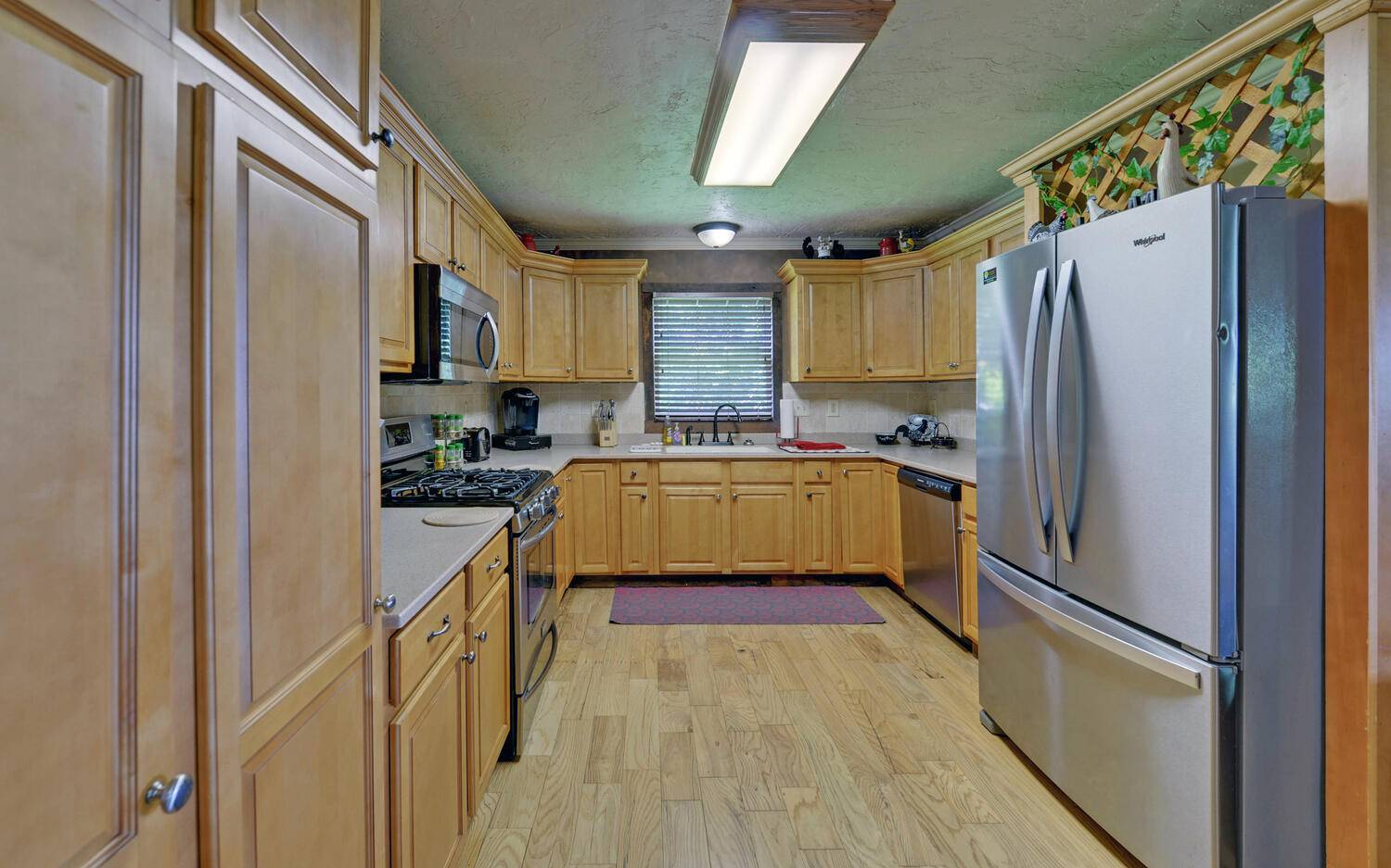 624 Talona Mountain Road Ellijay, GA 30536 - Photo 16 of 49 a kitchen with granite countertop a refrigerator and a sink