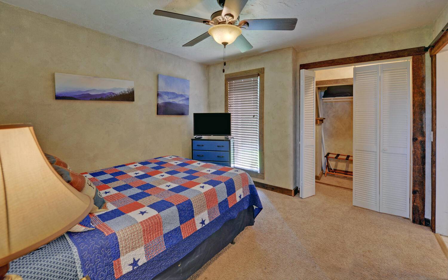 624 Talona Mountain Road Ellijay, GA 30536 - Photo 17 of 49 a bedroom with a bed and a chandelier