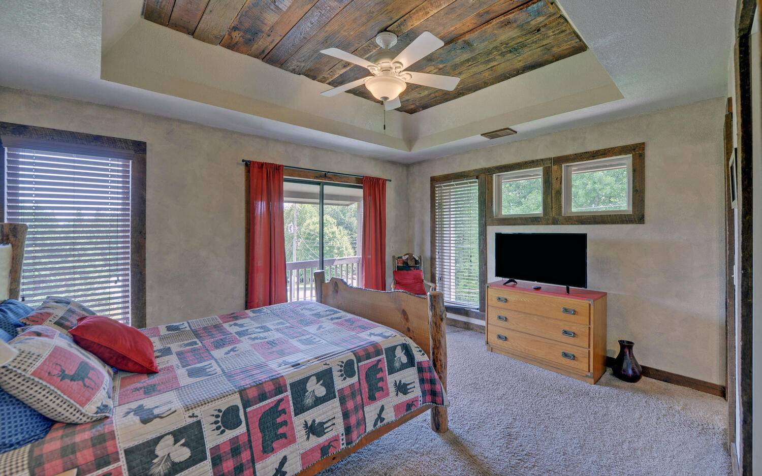 624 Talona Mountain Road Ellijay, GA 30536 - Photo 28 of 49 a bedroom with a bed and a flat screen tv
