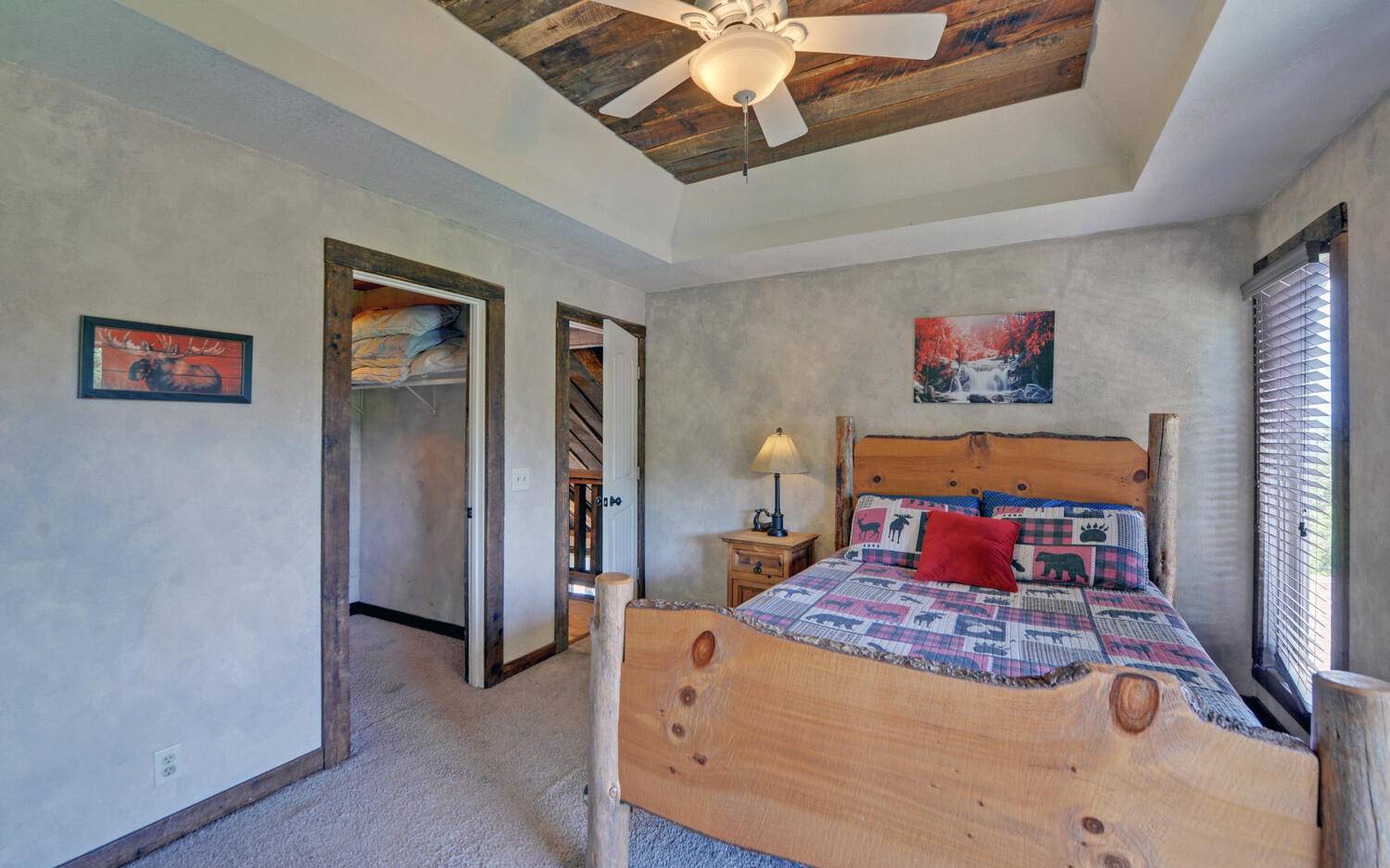 624 Talona Mountain Road Ellijay, GA 30536 - Photo 29 of 49 a bedroom with a large bed and a chandelier