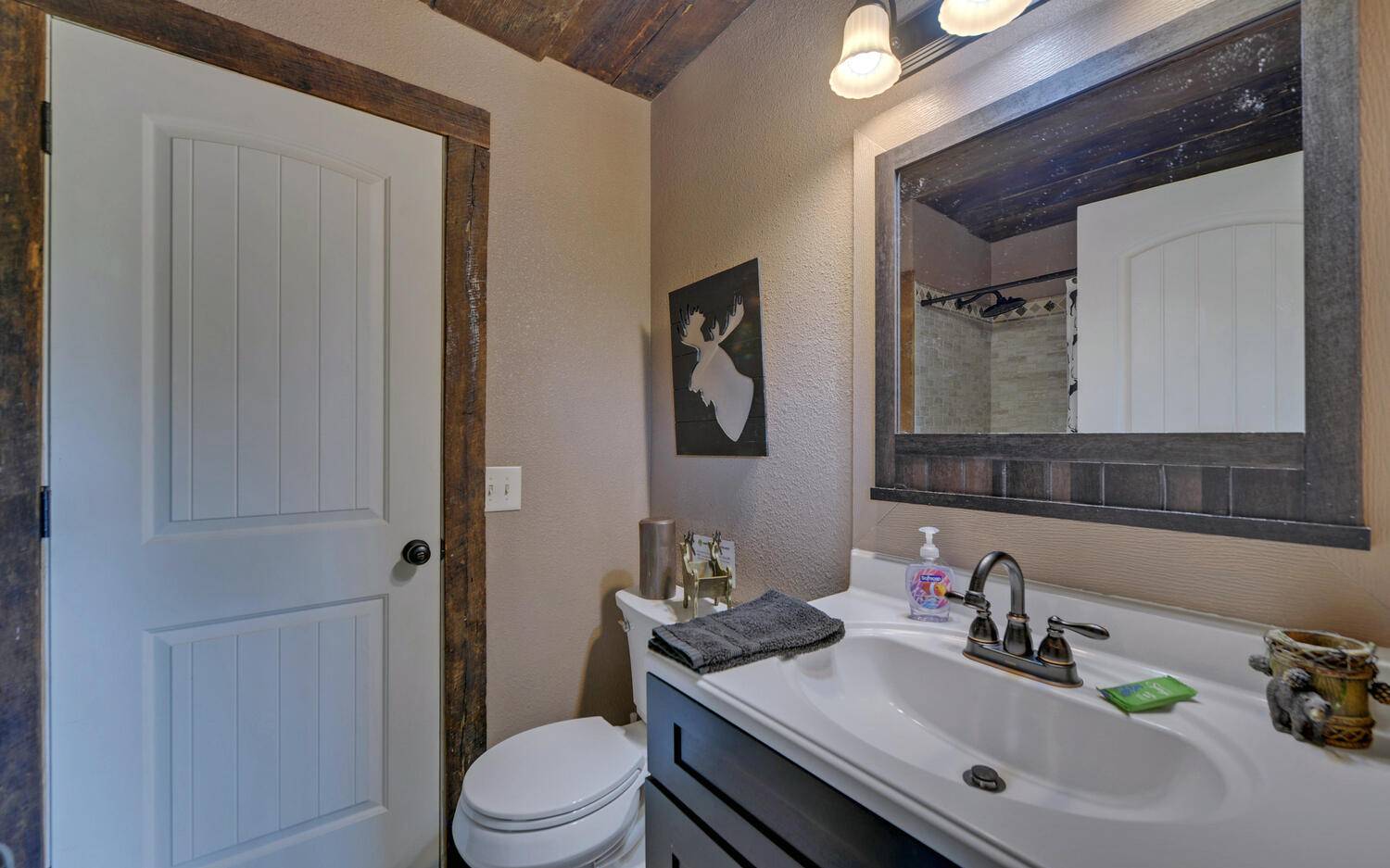 624 Talona Mountain Road Ellijay, GA 30536 - Photo 31 of 49 a bathroom with a sink vanity mirror and toilet