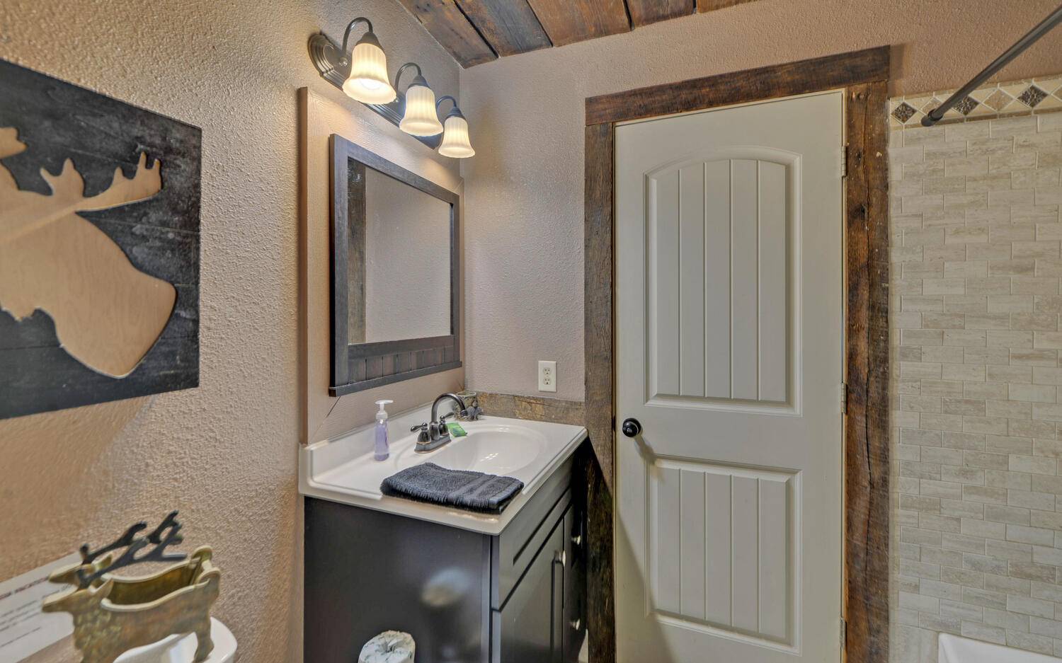 624 Talona Mountain Road Ellijay, GA 30536 - Photo 33 of 49 a bathroom with a sink a mirror and a mirror