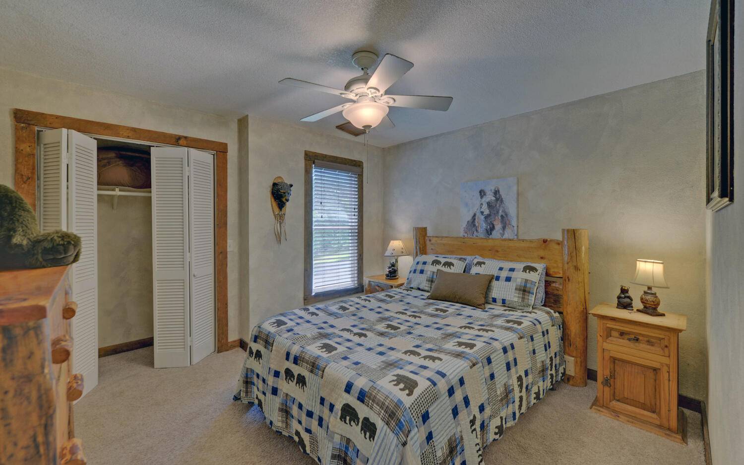 624 Talona Mountain Road Ellijay, GA 30536 - Photo 34 of 49 a bedroom with a large bed and a chandelier