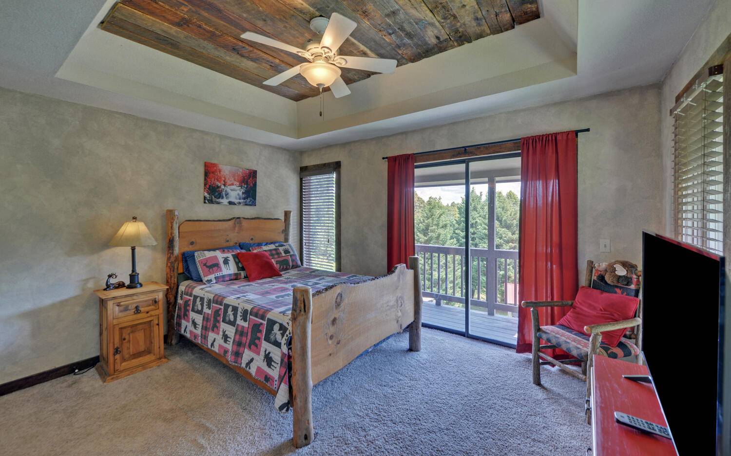 624 Talona Mountain Road Ellijay, GA 30536 - Photo 5 of 49 a bedroom with a bed and a chandelier
