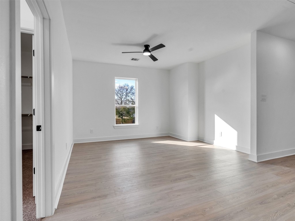 4421 Reed Road, Unit A AND B Houston, TX 77051 - Photo 12 of 27 a view of an empty room with a window and wooden floor