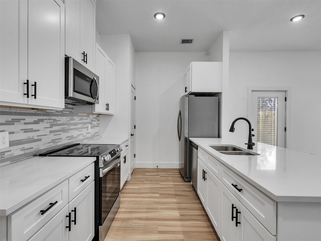 4421 Reed Road, Unit A AND B Houston, TX 77051 - Photo 10 of 27 a kitchen with stainless steel appliances granite countertop a stove and a sink