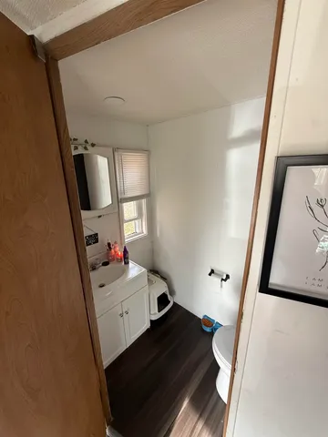 a bathroom with a sink mirror and window