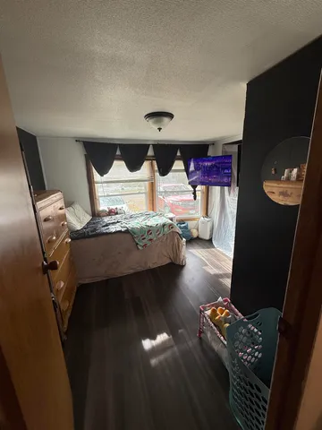 a bedroom with bed and window